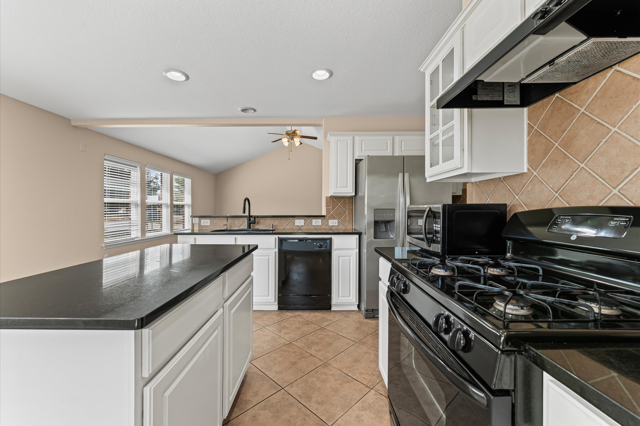 3010 Pathfinders Pass Spring, TX 77373 - Photo 9 of 26 a kitchen with stainless steel appliances granite countertop a sink stove and refrigerator