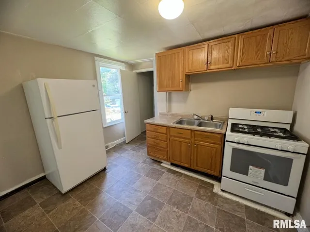 a kitchen with a refrigerator stove and cabinets