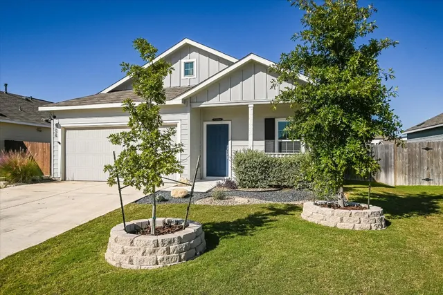 a front view of a house with a yard