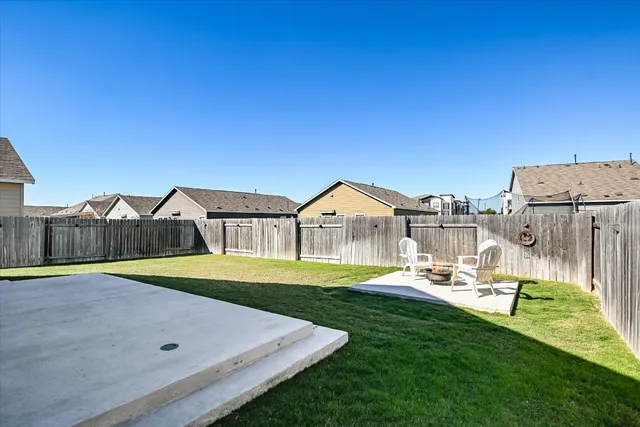 a view of a house with a big yard and potted plants