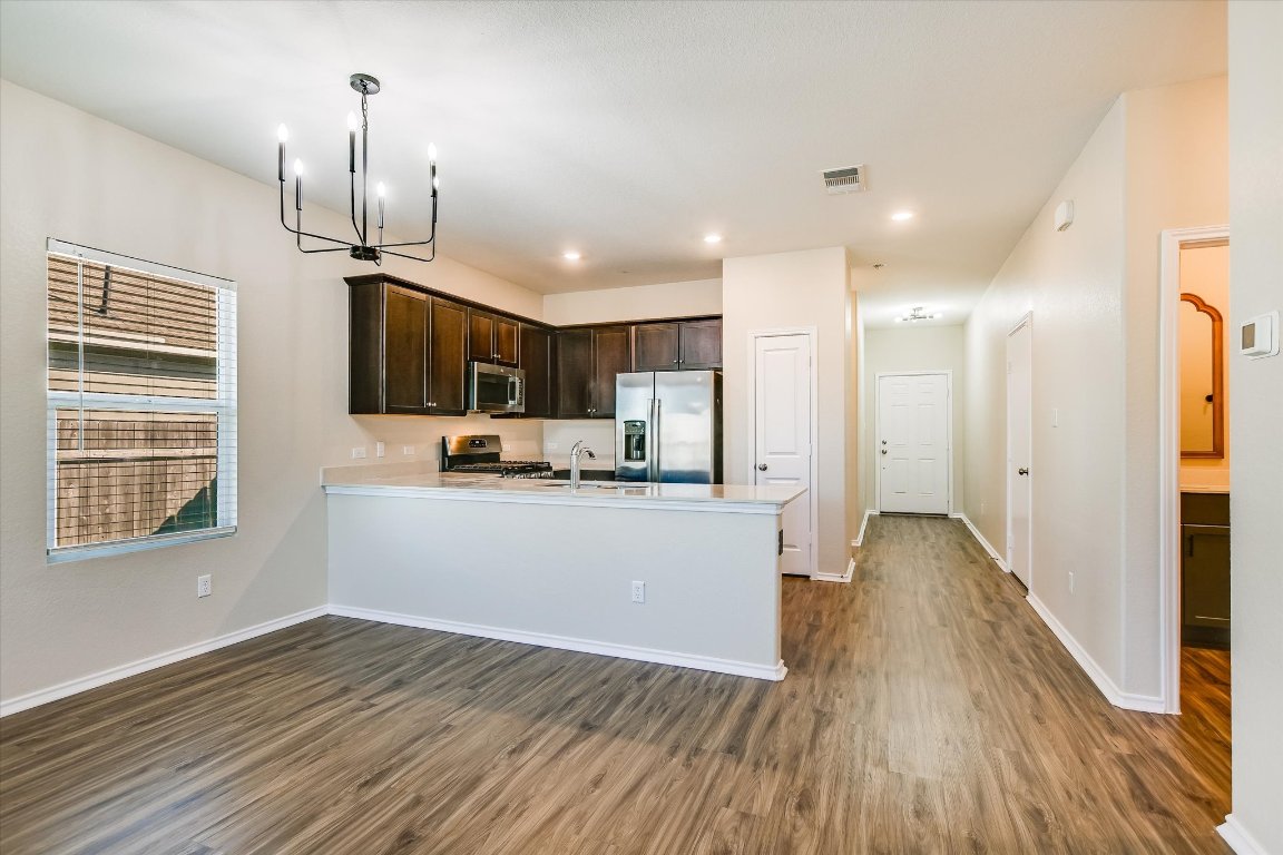 108 Akela Way Georgetown, TX 78626 - Photo 4 of 15 a view of kitchen with wooden floor electronic appliances and window