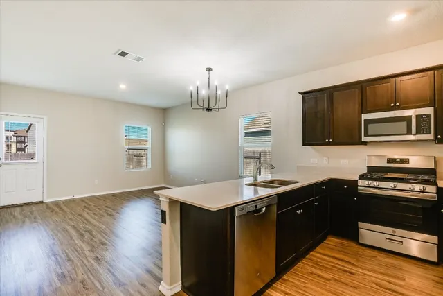 a kitchen with a sink stove and microwave