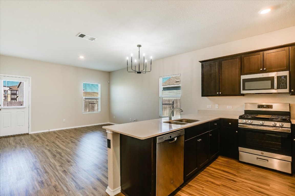 108 Akela Way Georgetown, TX 78626 - Photo 5 of 15 a kitchen with a sink stove and microwave