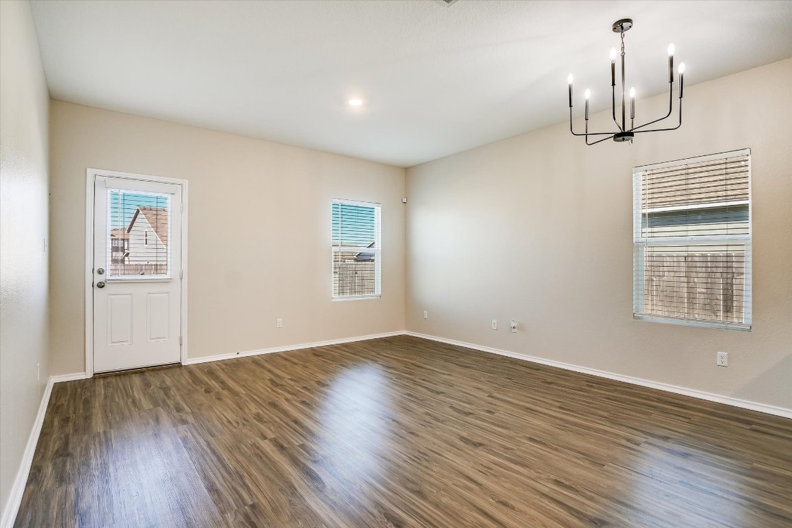 108 Akela Way Georgetown, TX 78626 - Photo 6 of 15 a view of empty room with wooden floor and window