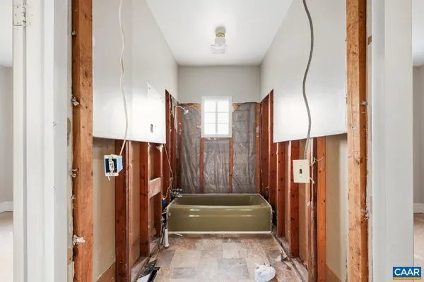 a bathroom with a glass shower door and a bathroom