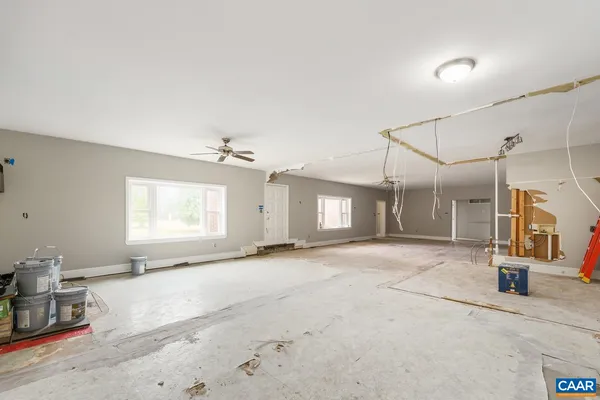 a view of a livingroom with a furniture and chandelier fan