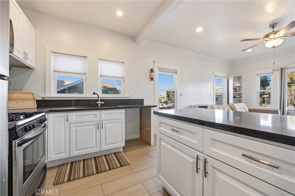 325 East 14th Street Long Beach, CA 90813 - Photo 12 of 21 a kitchen with granite countertop white cabinets and white appliances