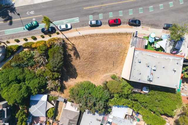 an aerial view of residential house with outdoor space and trees all around