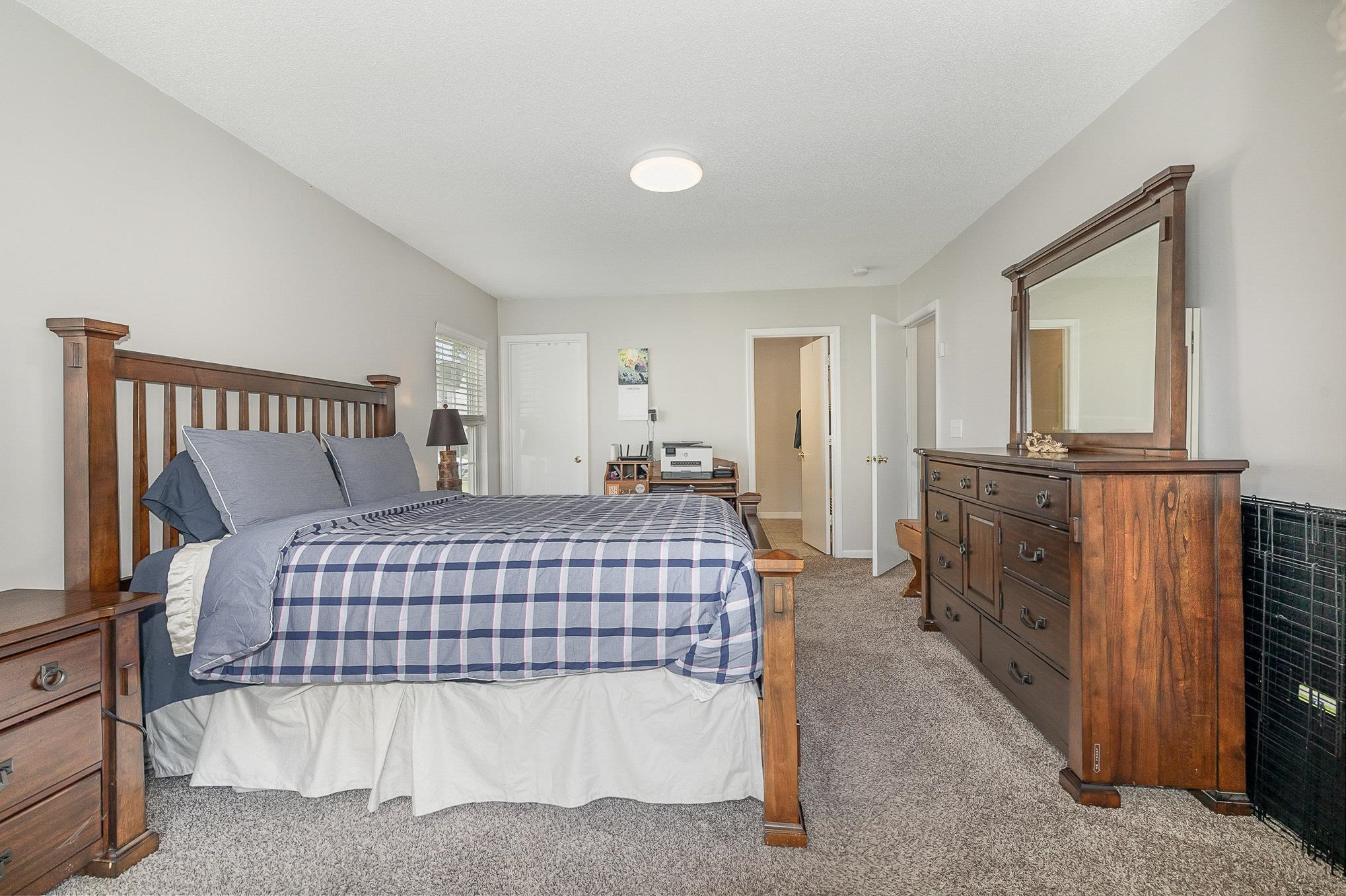 3740 Tryon Ridge Drive Raleigh, NC 27610 - Photo 14 of 20 a bedroom with a bed and dresser with mirror