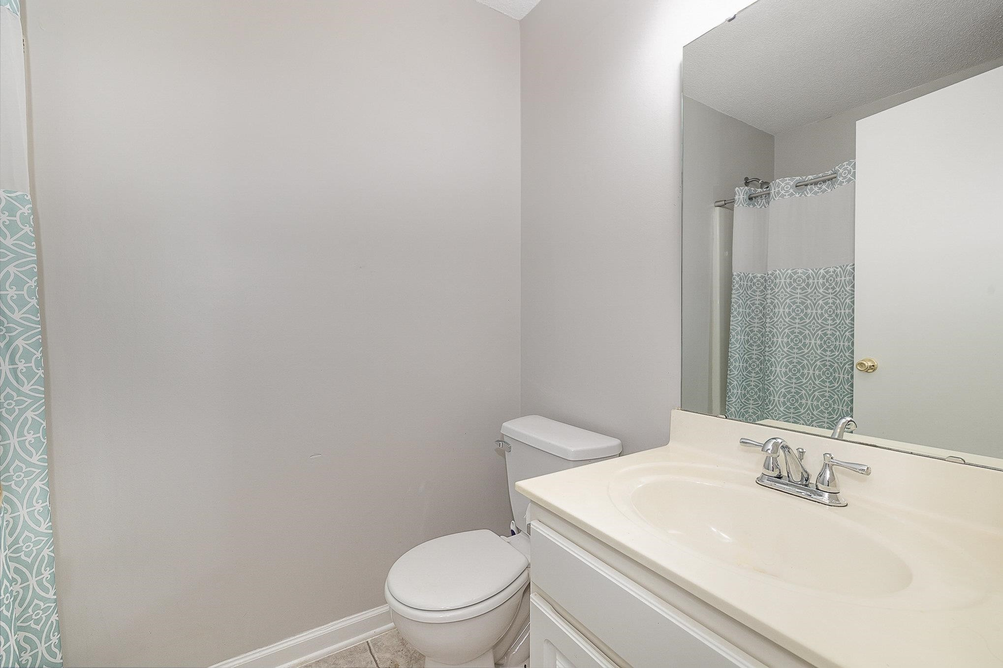 3740 Tryon Ridge Drive Raleigh, NC 27610 - Photo 18 of 20 a white toilet sitting next to a bathroom sink