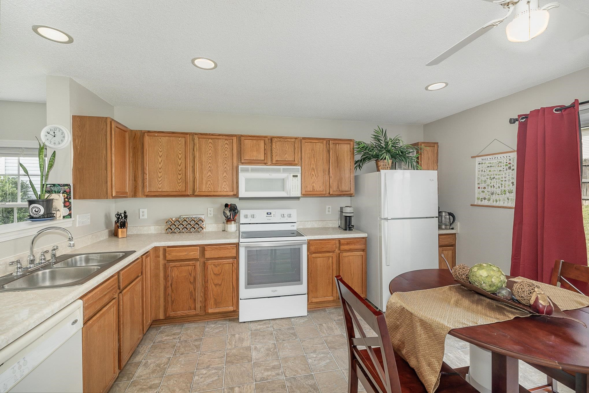 3740 Tryon Ridge Drive Raleigh, NC 27610 - Photo 3 of 20 a kitchen with a sink a refrigerator and chairs
