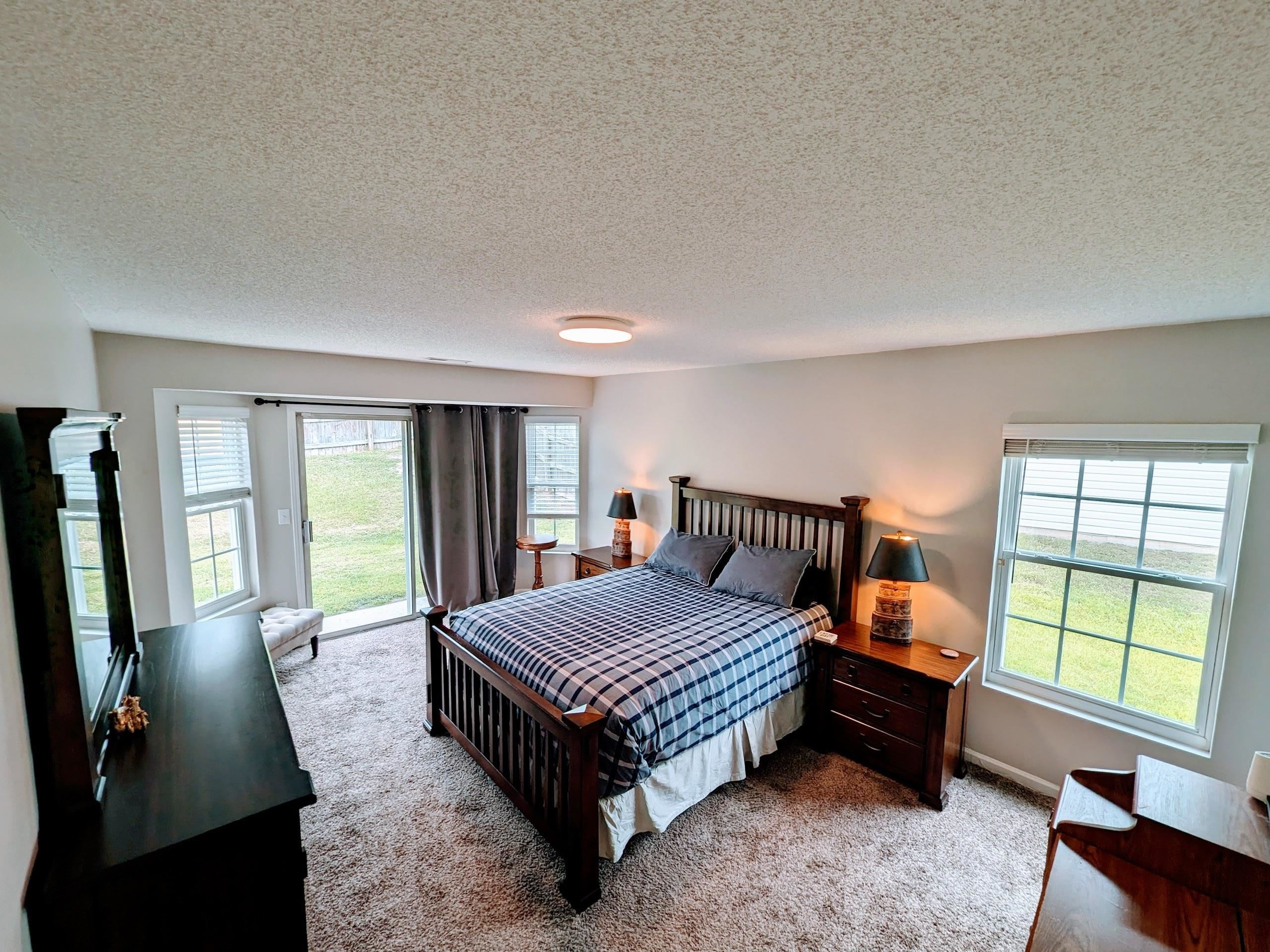 3740 Tryon Ridge Drive Raleigh, NC 27610 - Photo 4 of 20 a bedroom with a bed wooden floor and a flat screen tv