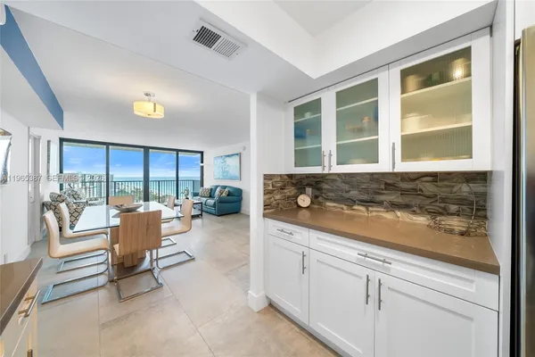 a spacious bedroom with a bed and glass window