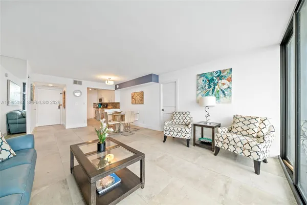 a bedroom with a bed chandelier and a window