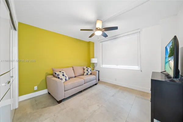 a living room with furniture and a potted plant