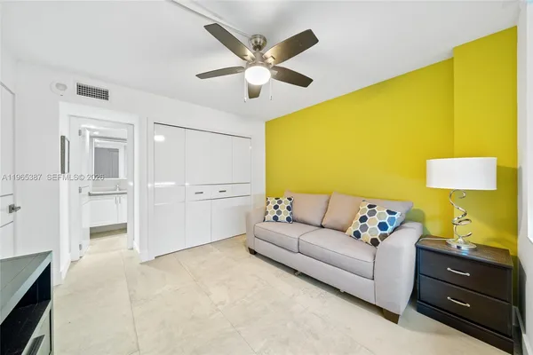 a living room with furniture and a potted plant