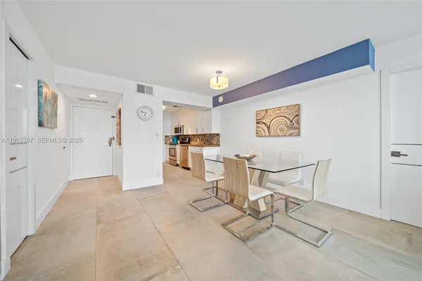 a kitchen with a sink and white cabinets
