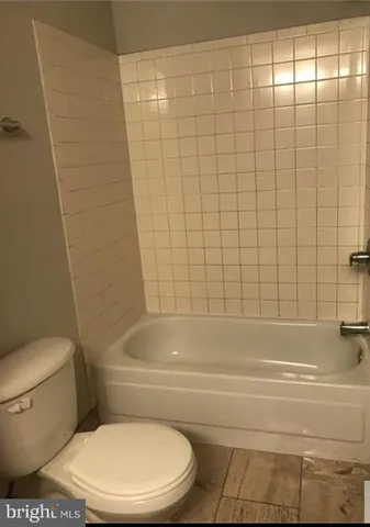 a bathroom with a toilet and bathtub