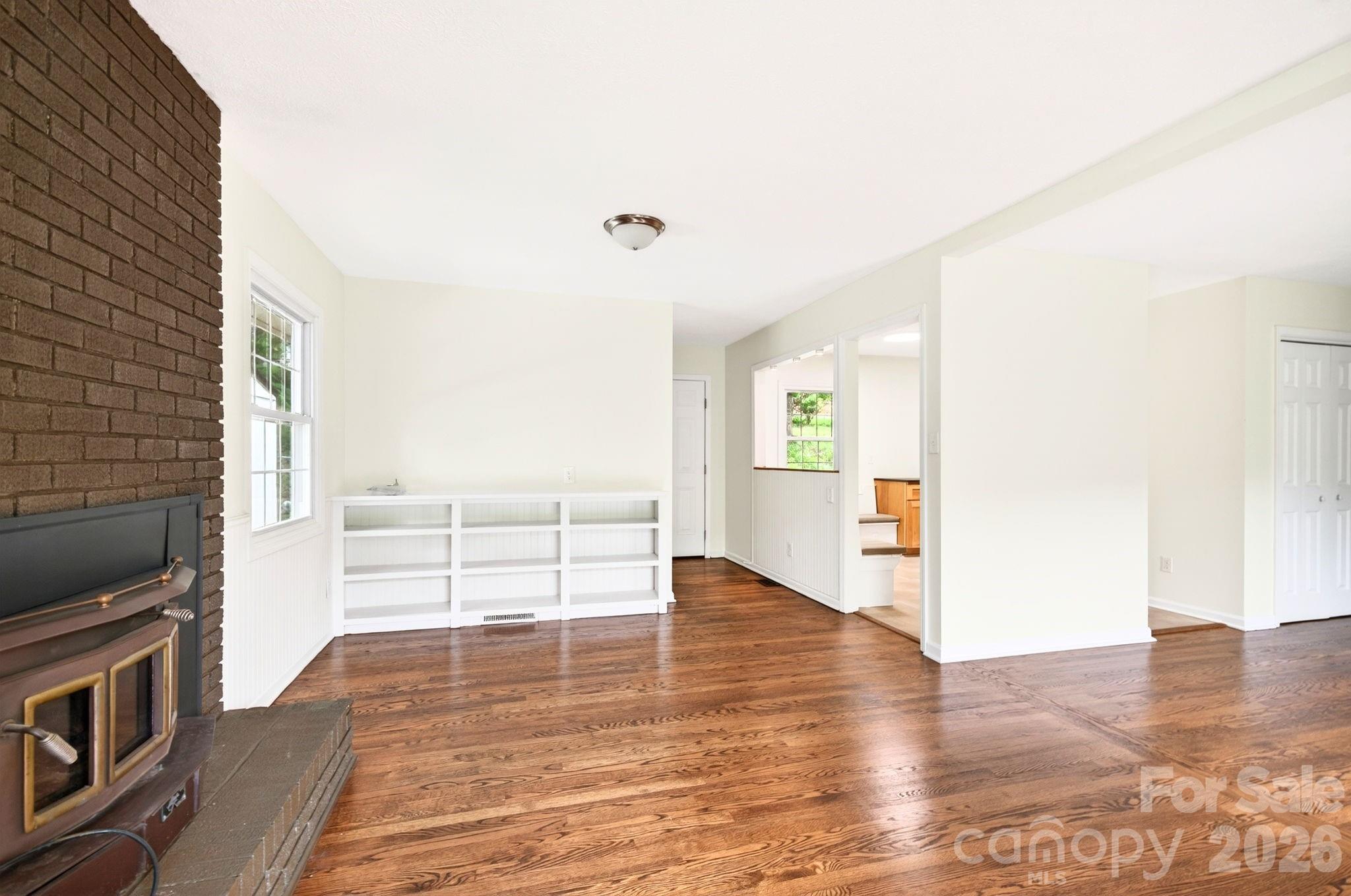 34 Wolfe Cove Road Asheville, NC 28804 - Photo 28 of 42 a view of empty room with wooden floor and fireplace