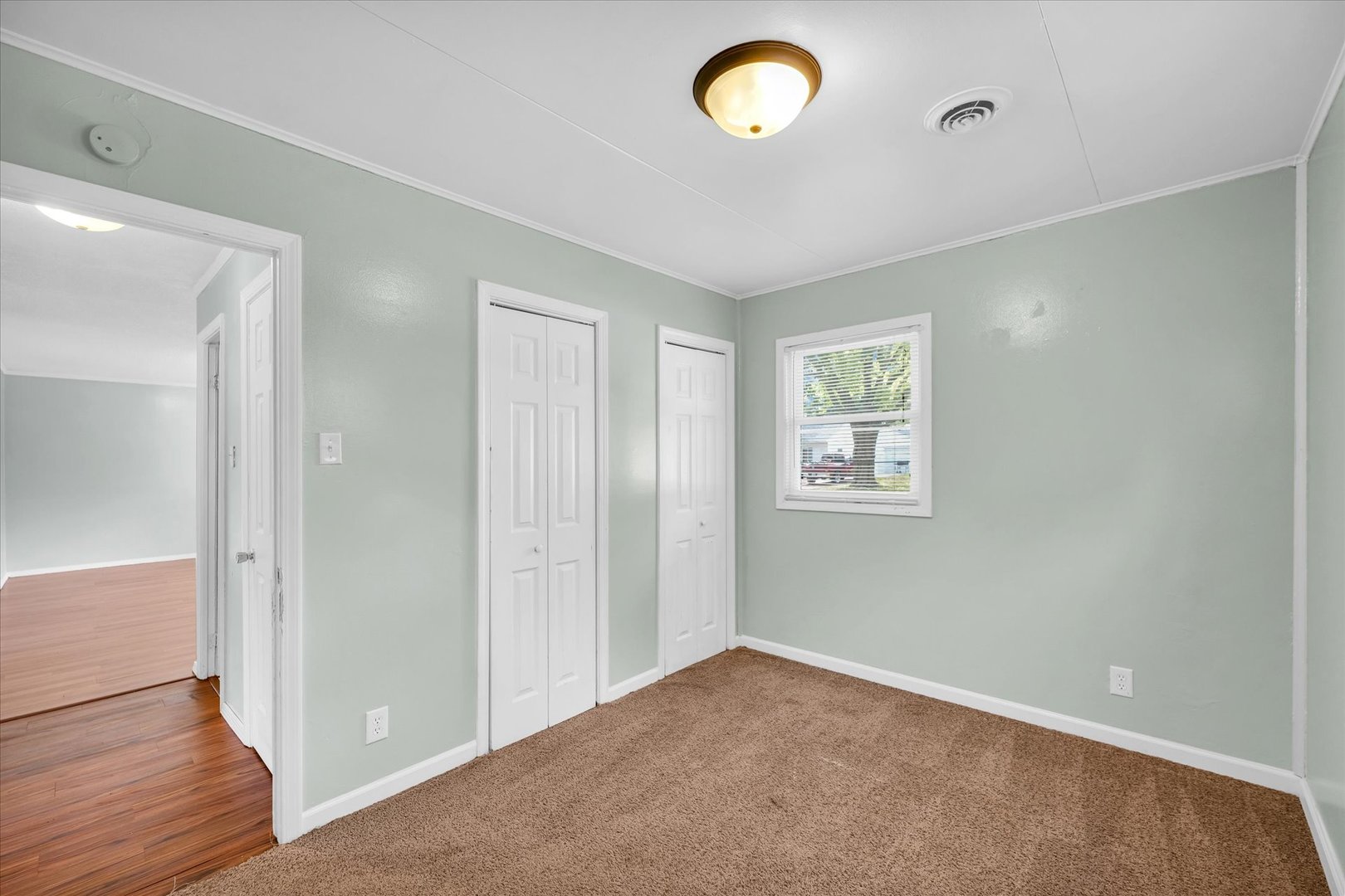 1345 Sunset Drive Rantoul, IL 61866 - Photo 14 of 22 an empty room with wooden floor and windows
