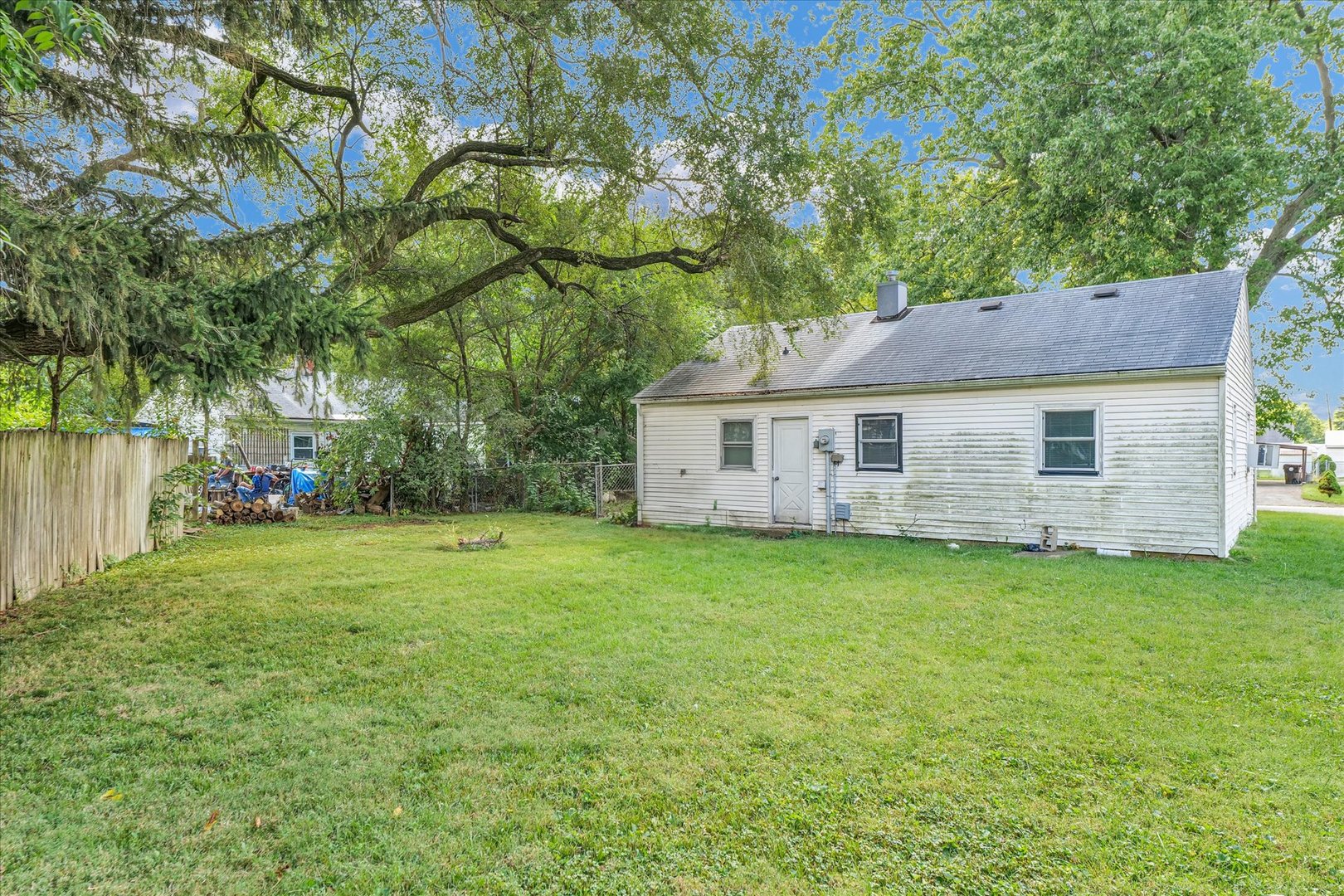 1345 Sunset Drive Rantoul, IL 61866 - Photo 20 of 22 a aerial view of a house next to a yard with big trees
