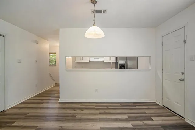 a view of room with wooden floor