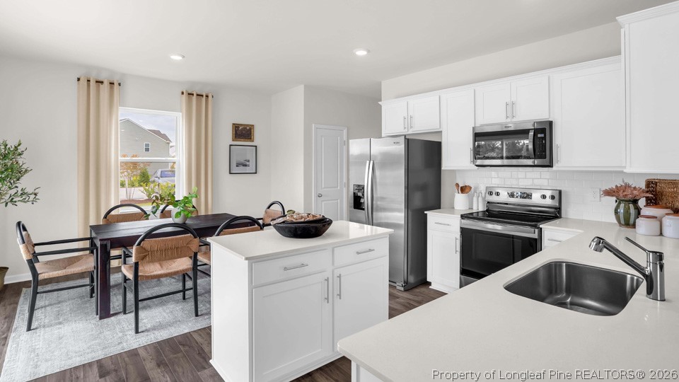 143 Rashford Way Raeford, NC 28376 - Photo 11 of 33 a kitchen with a sink white cabinets and stainless steel appliances