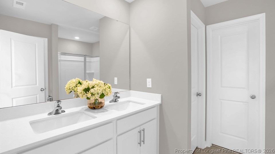 143 Rashford Way Raeford, NC 28376 - Photo 29 of 33 a bathroom with a sink vanity and a mirror