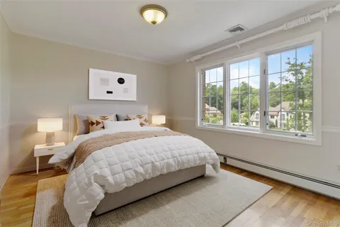 a bedroom with a bed and a large window