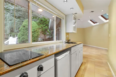 a large white kitchen with a large window