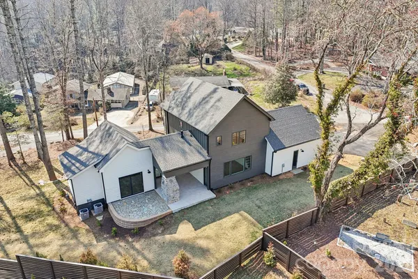 an aerial view of a house with backyard space and patio