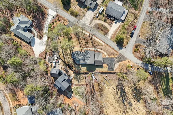 an aerial view of a house with a yard