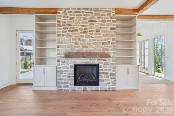 a front view of a house with white walls and a fireplace