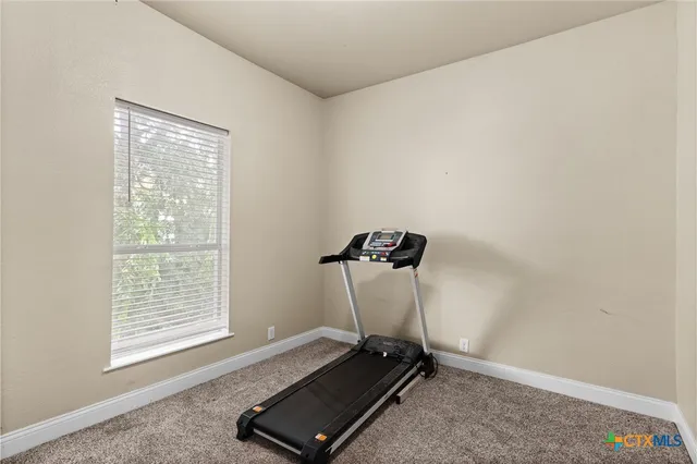 a room with gym equipment and a window