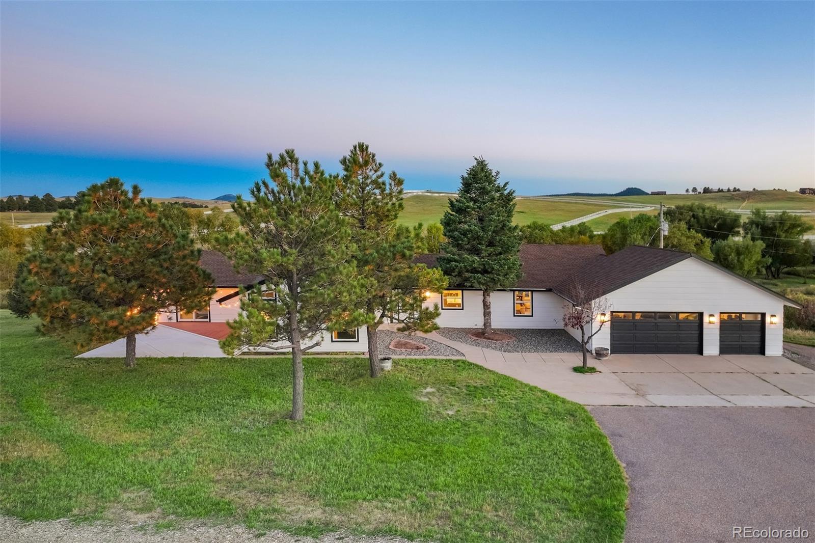 850 West Fox Farm Road Larkspur, CO 80118 - Photo 21 of 50 a house with green field in front of it