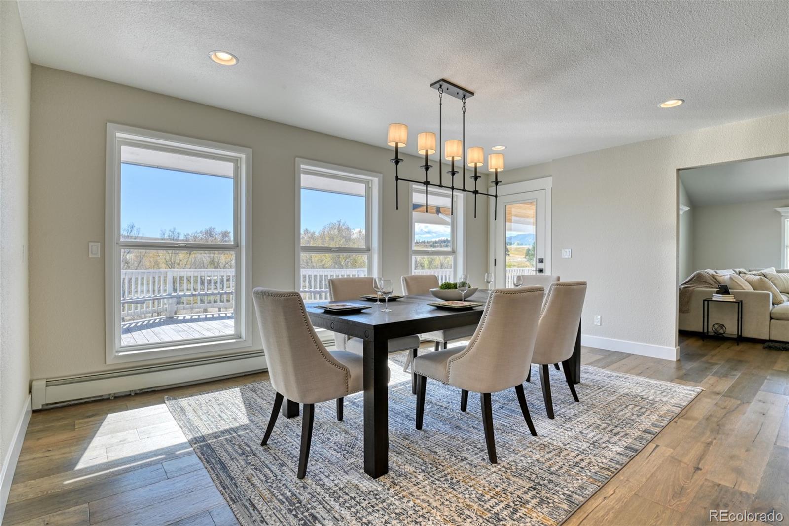 850 West Fox Farm Road Larkspur, CO 80118 - Photo 27 of 50 a view of a dining room with furniture window and wooden floor