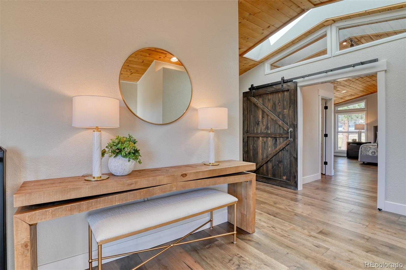 850 West Fox Farm Road Larkspur, CO 80118 - Photo 29 of 50 a living room with wooden floor and furniture
