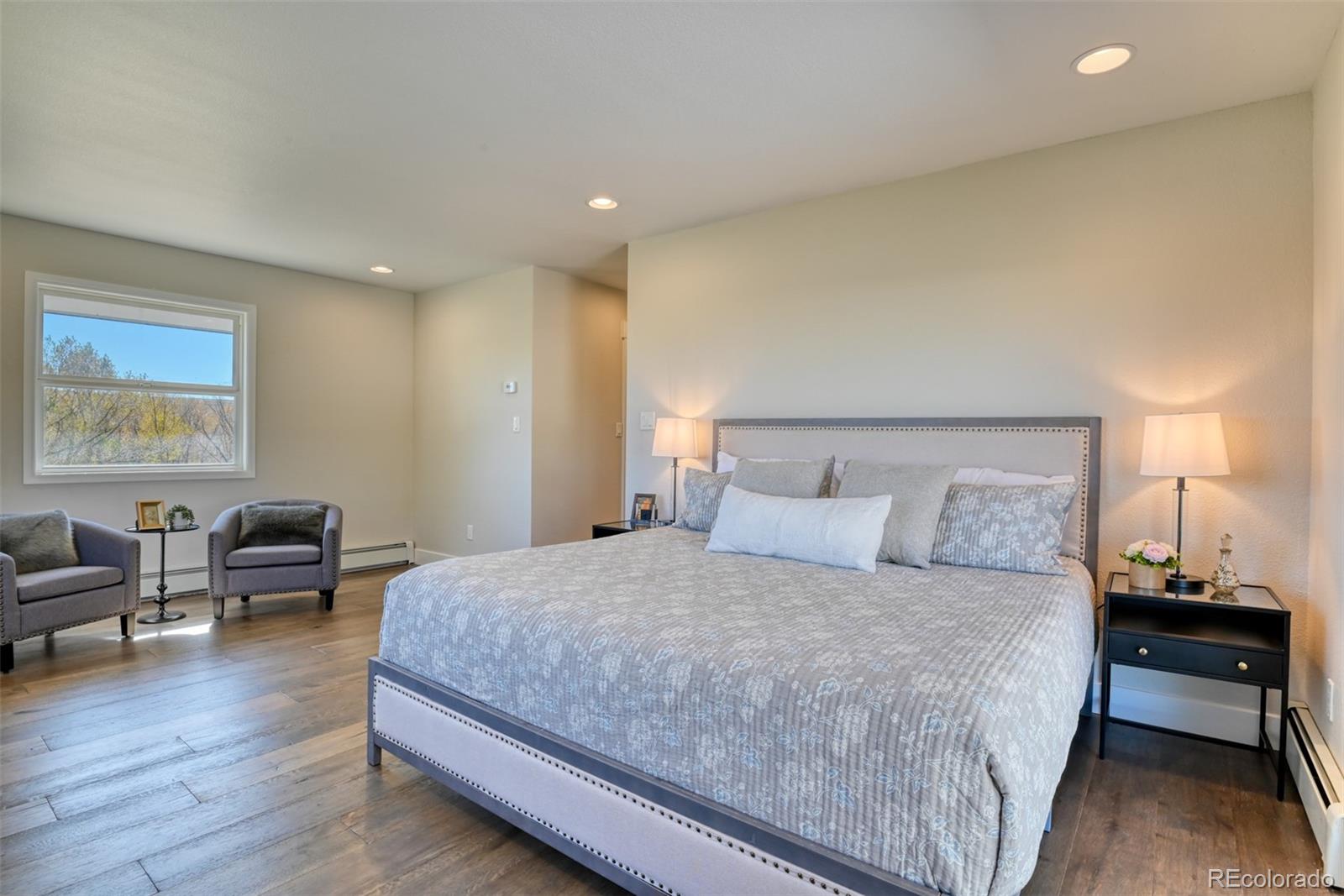 850 West Fox Farm Road Larkspur, CO 80118 - Photo 30 of 50 a bedroom with a bed and wooden floor