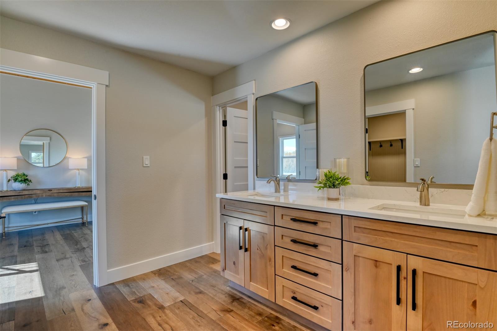 850 West Fox Farm Road Larkspur, CO 80118 - Photo 32 of 50 a spacious bathroom with a granite countertop sink and a mirror