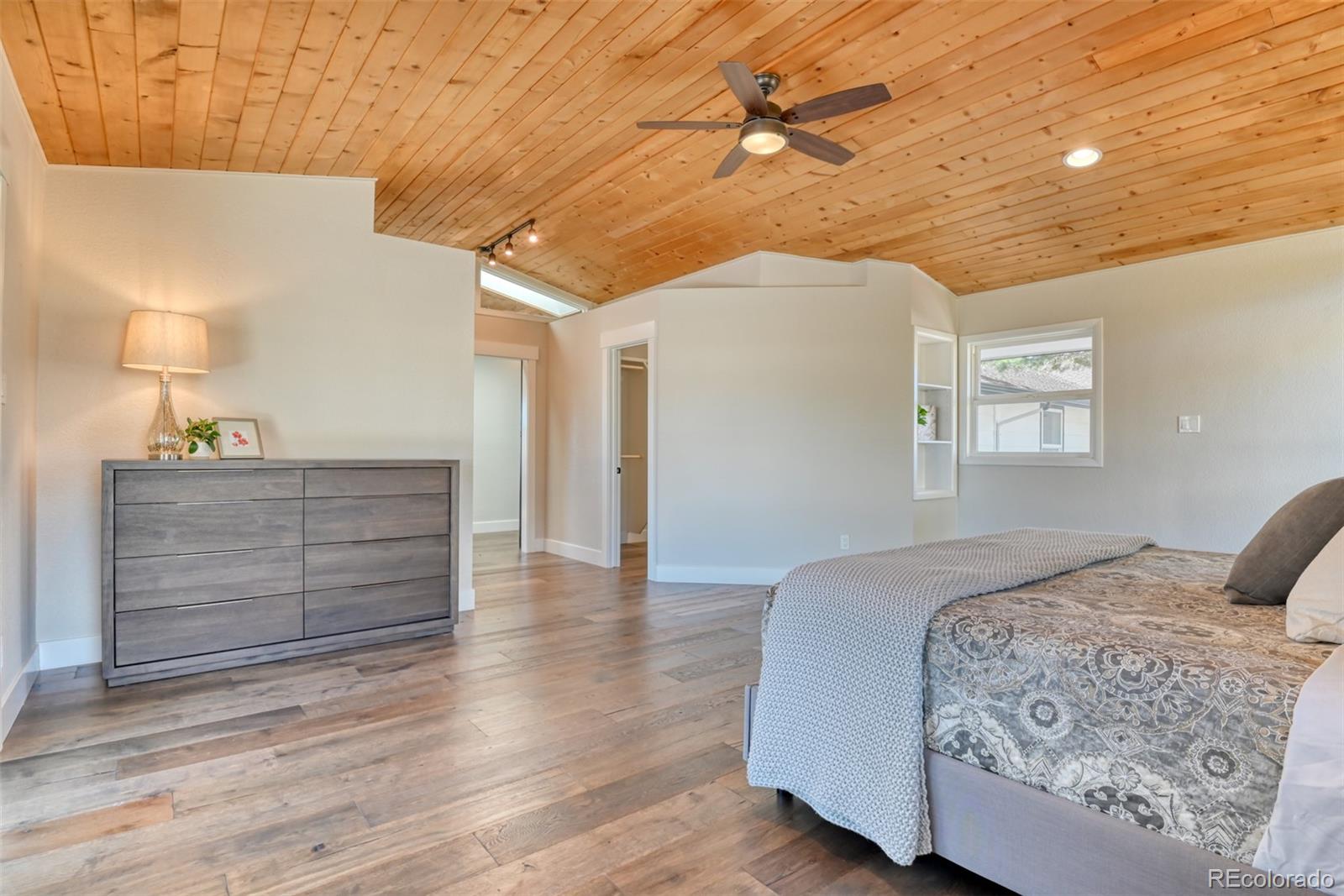 850 West Fox Farm Road Larkspur, CO 80118 - Photo 34 of 50 a bedroom with a bed and a dresser