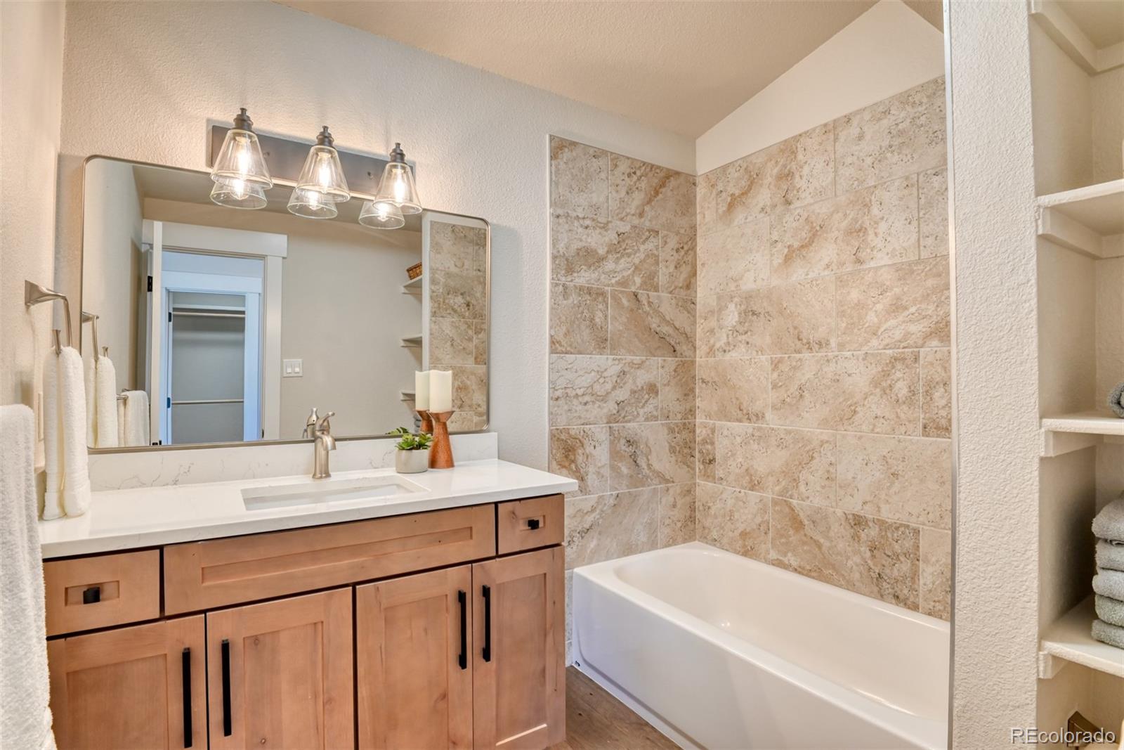 850 West Fox Farm Road Larkspur, CO 80118 - Photo 35 of 50 a bathroom with a sink a mirror and a bathtub