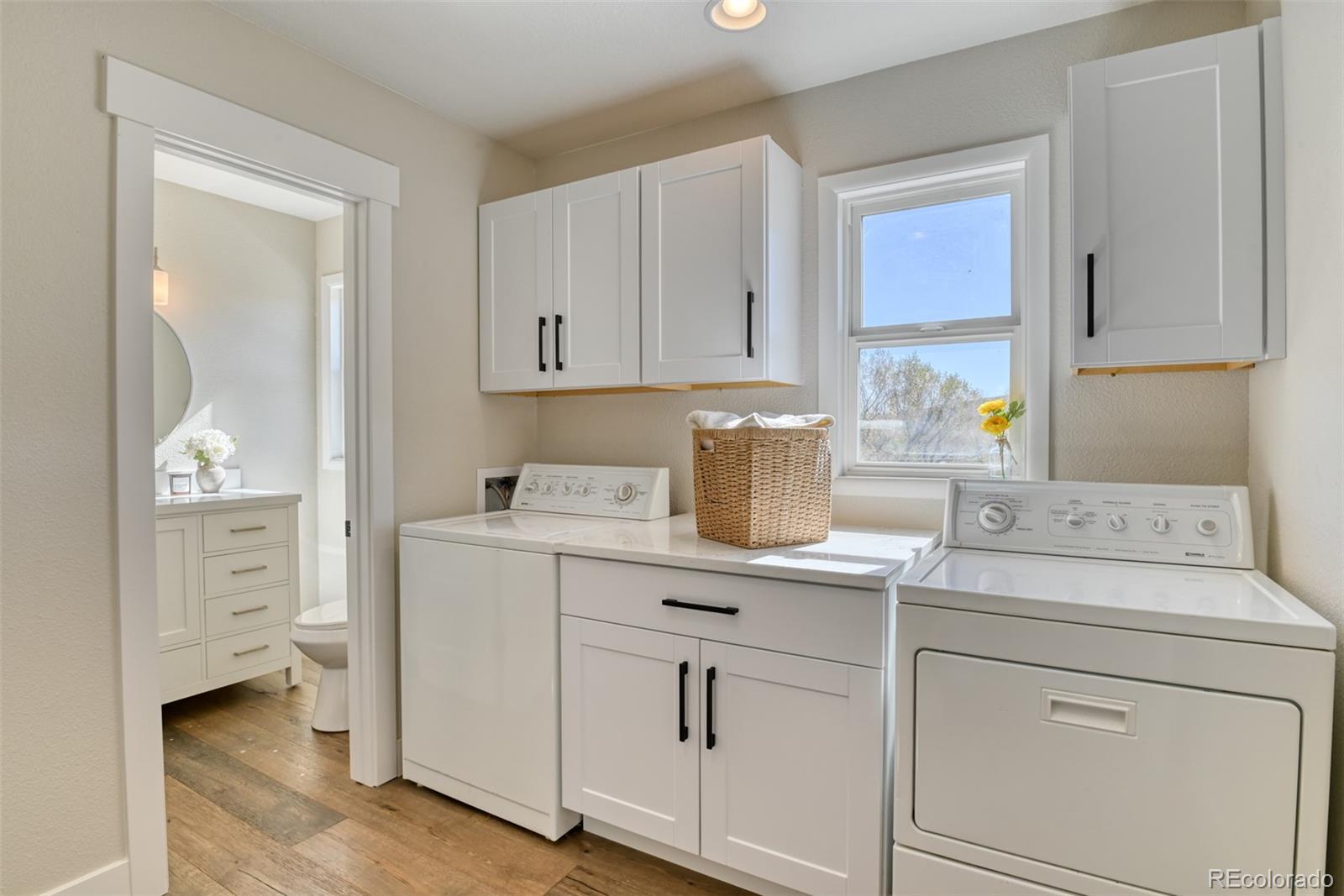 850 West Fox Farm Road Larkspur, CO 80118 - Photo 36 of 50 a utility room with cabinets washer and dryer