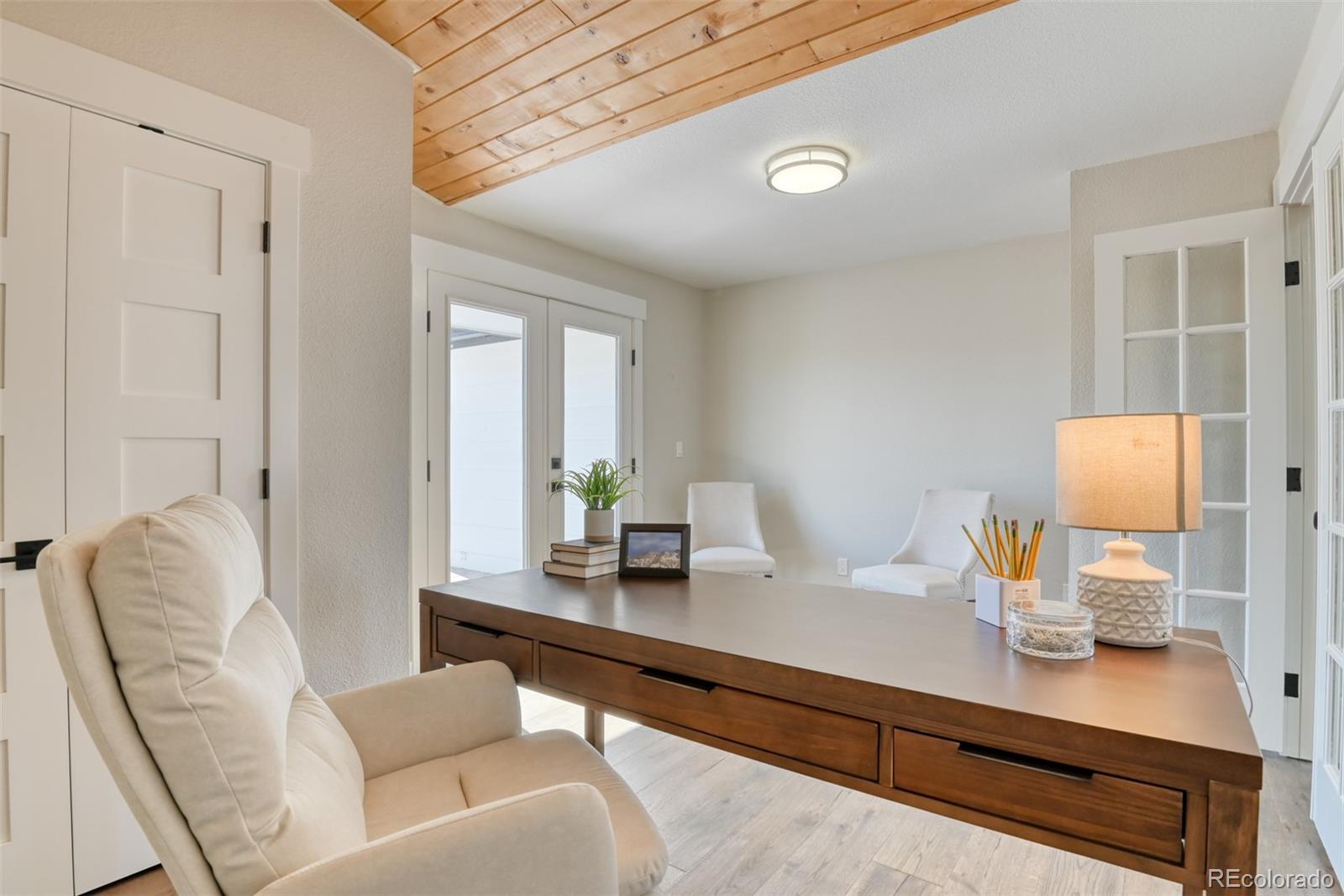 850 West Fox Farm Road Larkspur, CO 80118 - Photo 37 of 50 a living room with furniture and wooden floor