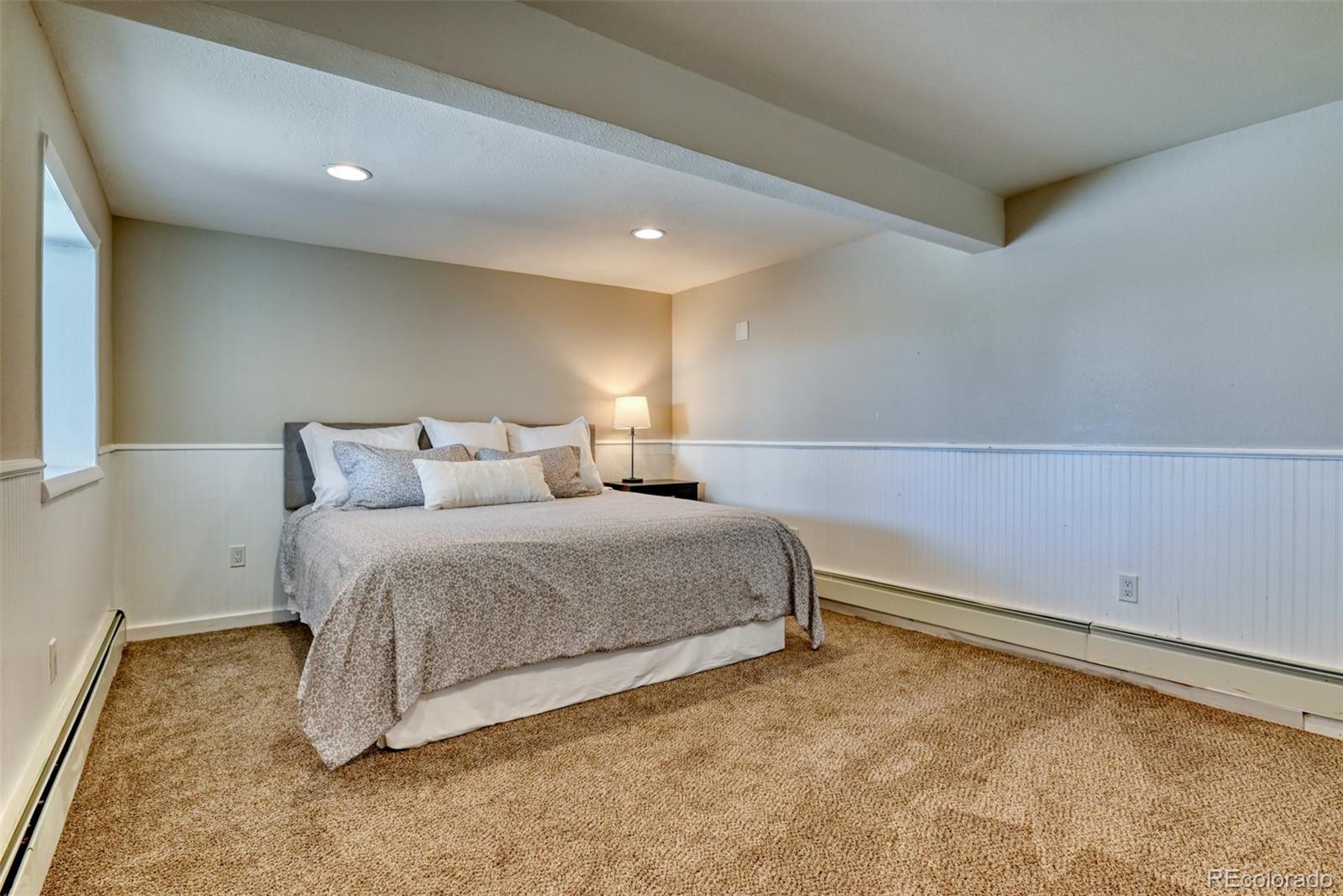 850 West Fox Farm Road Larkspur, CO 80118 - Photo 39 of 50 a bedroom with a bed and a cabinets