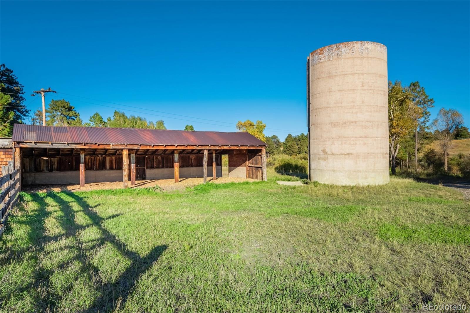 850 West Fox Farm Road Larkspur, CO 80118 - Photo 43 of 50 a view of a house with a backyard