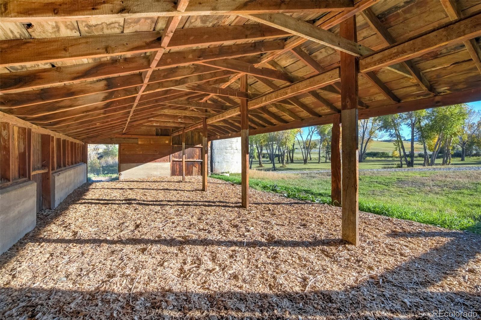850 West Fox Farm Road Larkspur, CO 80118 - Photo 44 of 50 a view of a backyard with wooden fence