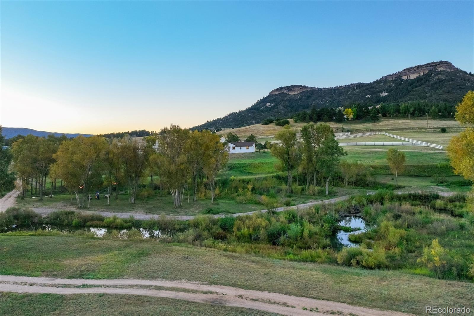 850 West Fox Farm Road Larkspur, CO 80118 - Photo 49 of 50 a view of a lake with a mountain in the background