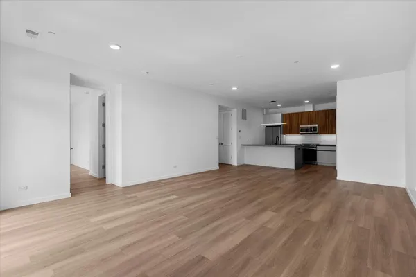 a view of kitchen with microwave and cabinets