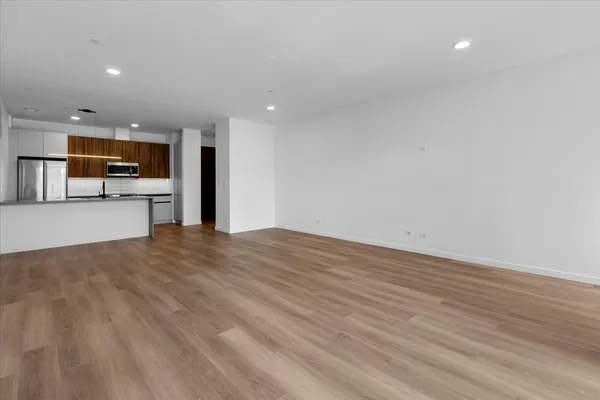 a view of a kitchen with a sink and a refrigerator