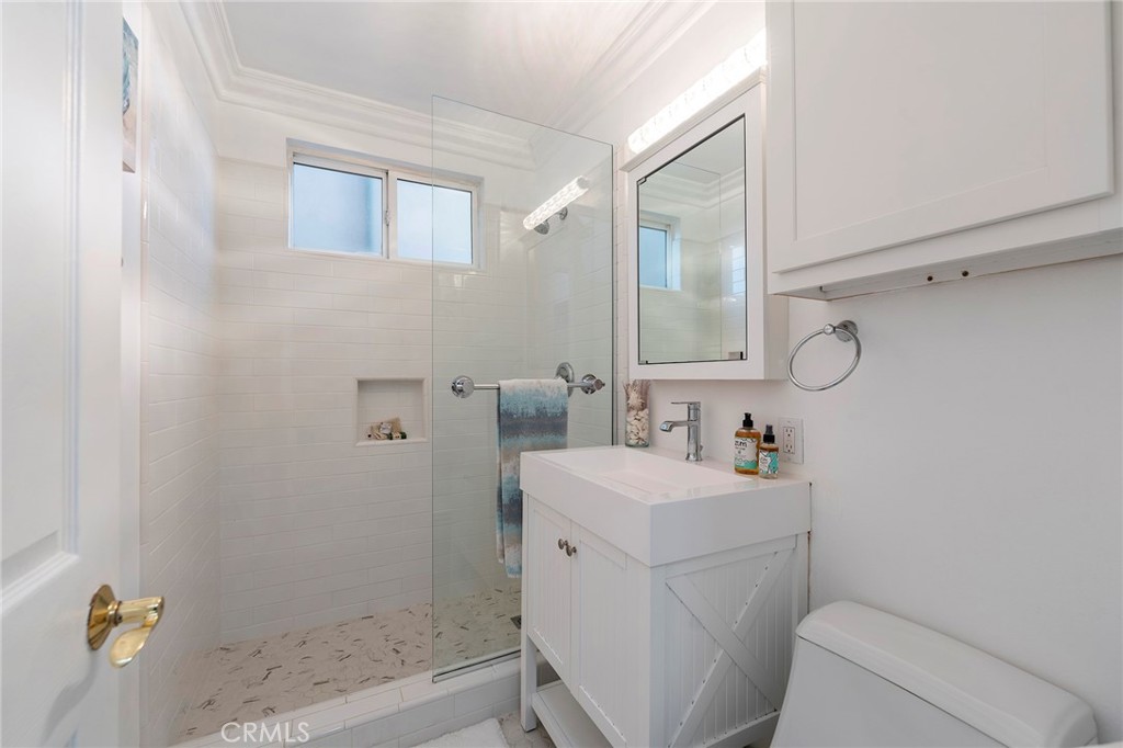 1728 The Strand, Unit 1 Hermosa Beach, CA 90254 - Photo 11 of 16 a bathroom with a sink a toilet and shower